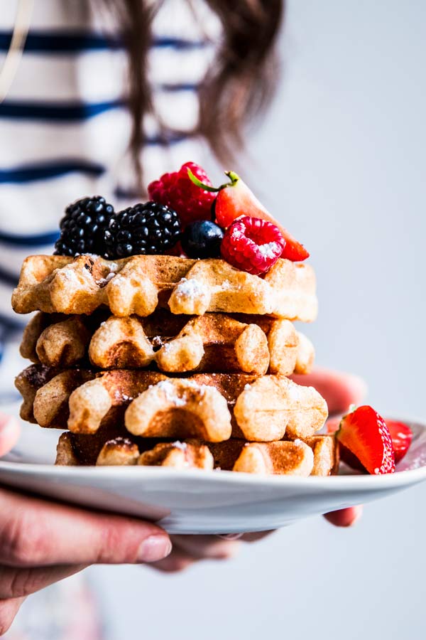woman holding a plate with healthy waffles