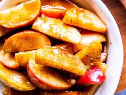 healthy cinnamon apples in a white bowl