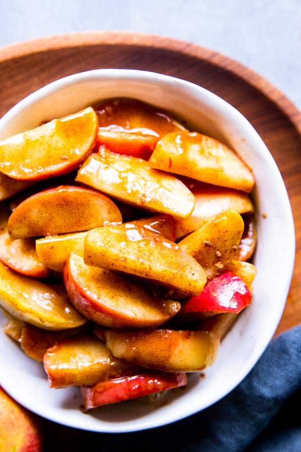 healthy cinnamon apples in a white bowl