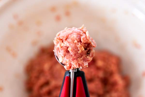 scooping meat for homemade meatballs