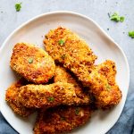 low carb oven fried fish on a plate with a dark napkin