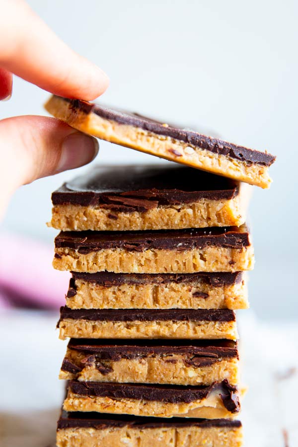 taking a peanut butter bar off a stack of bars