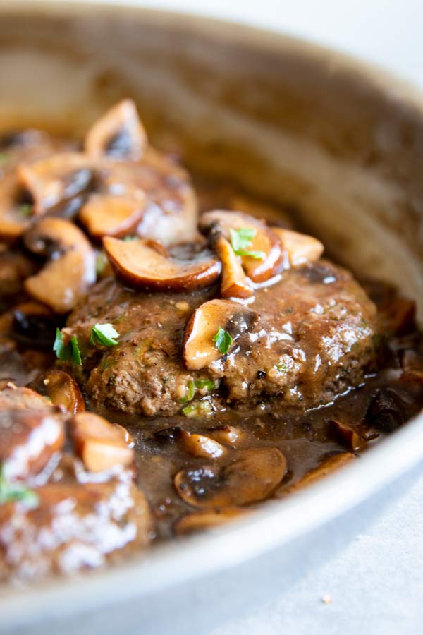 close up photo of salisbury steak in mushroom gravy