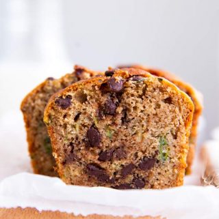 sliced healthy chocolate chip zucchini bread on a wooden chopping board