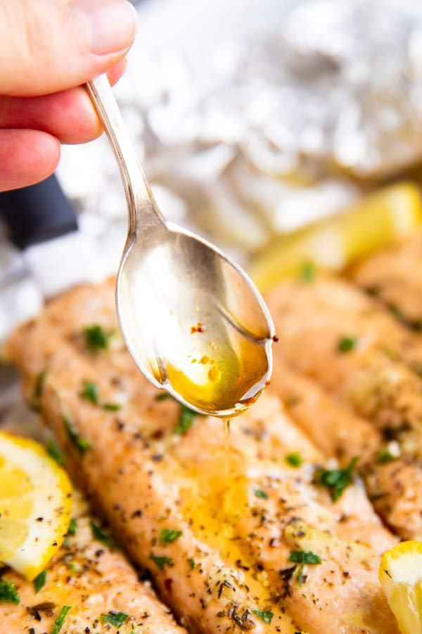 drizzling butter over salmon