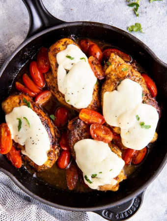 black cast iron skillet with balsamic glazed caprese chicken