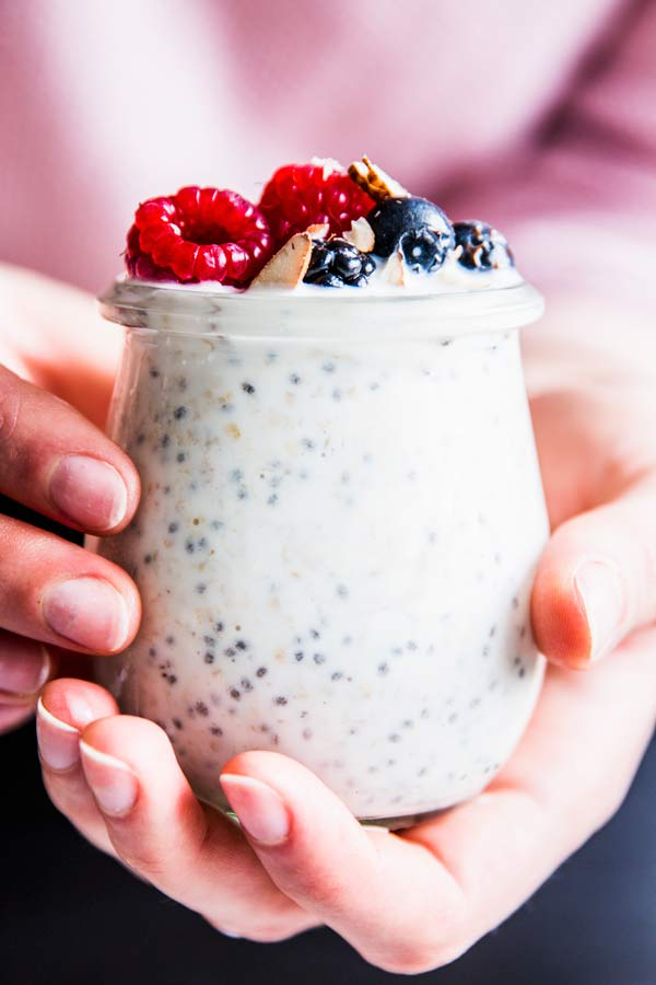 woman holding a jar of overnight oats