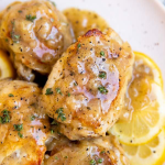 close up photo of chicken thigh in lemon sauce