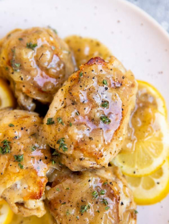 close up photo of chicken thigh in lemon sauce