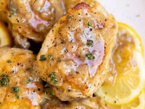 close up photo of chicken thigh in lemon sauce