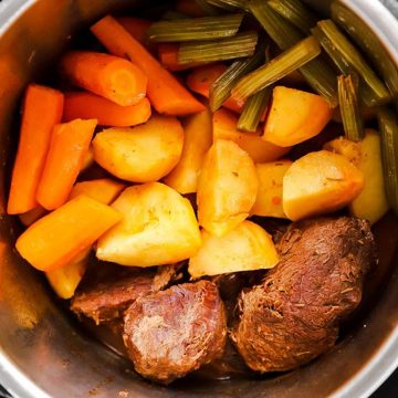 pressure cooker with ingredients for pot roast