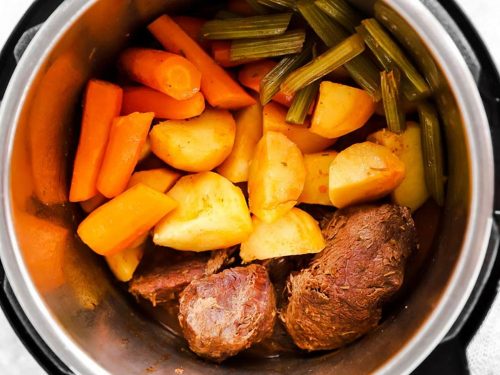 pressure cooker with ingredients for pot roast