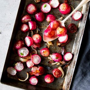 black tray with roasted radishes