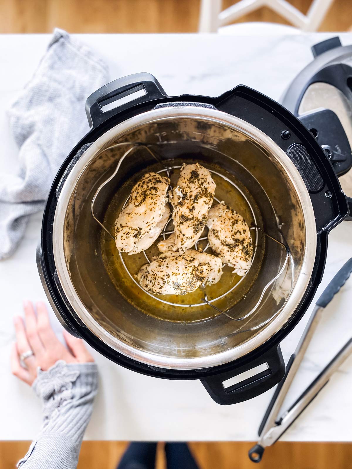 overhead view on instant pot with cooked chicken breast