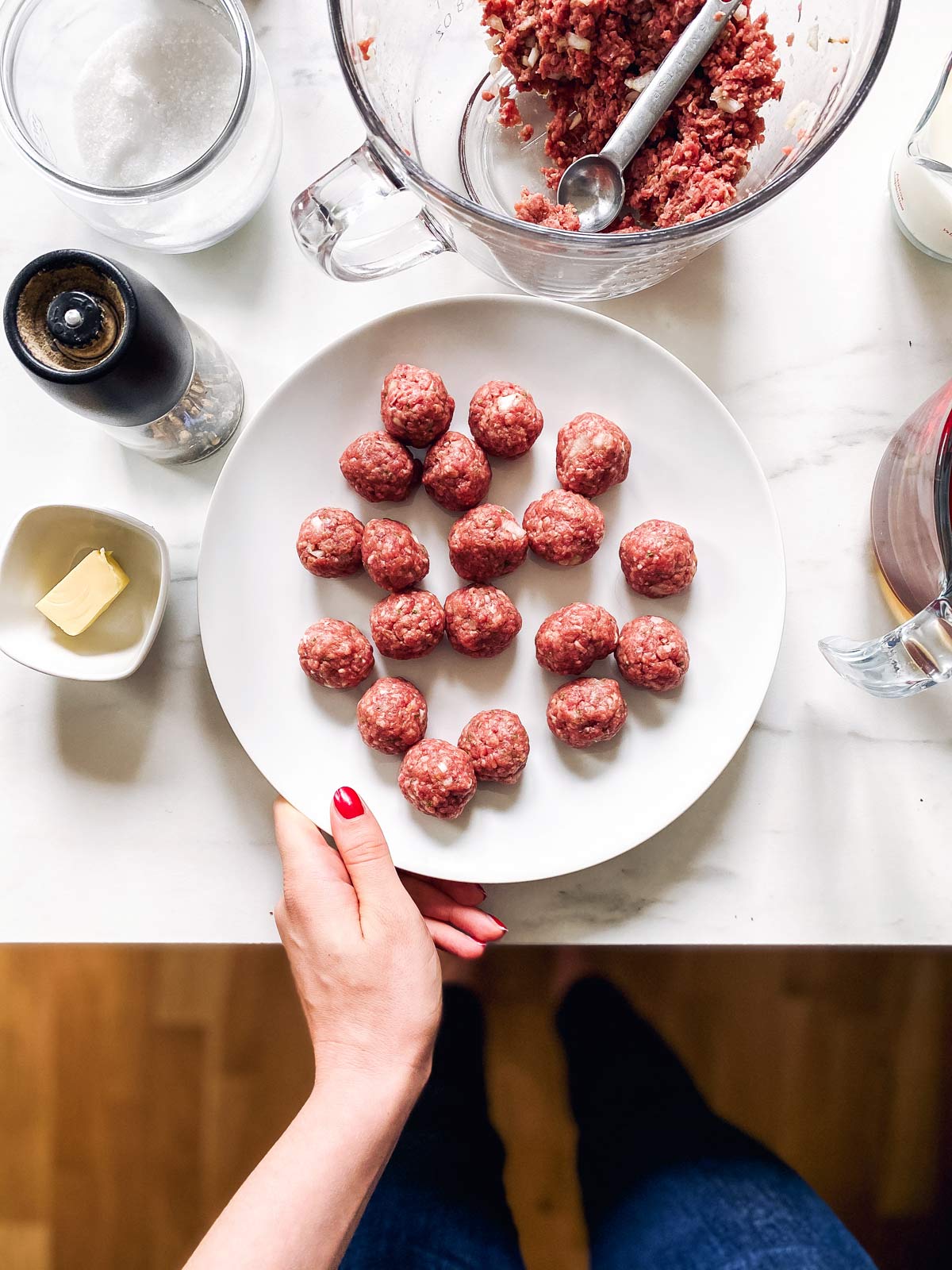 plate with raw meatballs on a counter