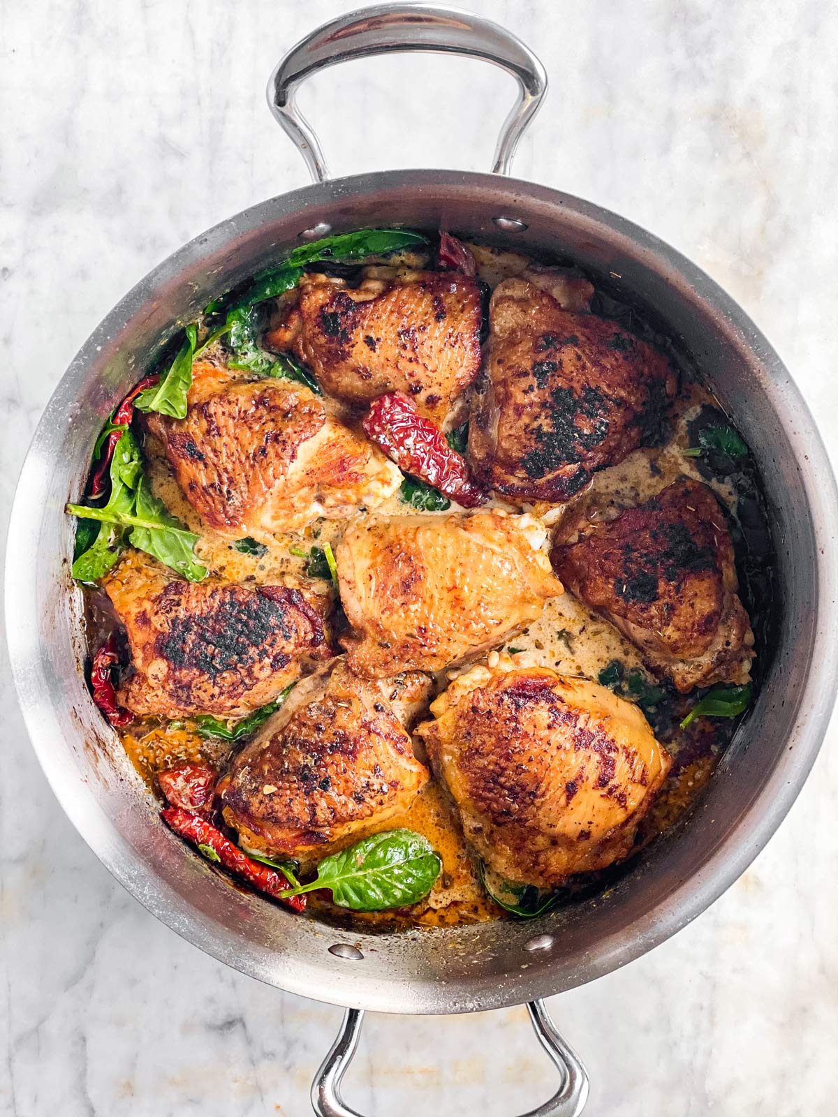skillet with tuscan chicken before broiling
