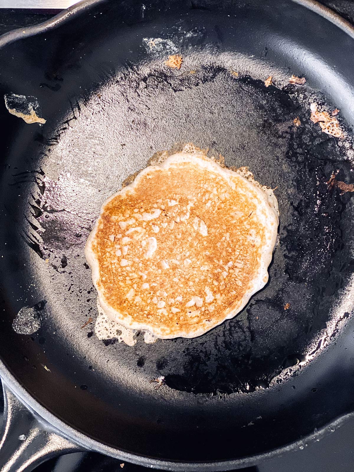cooked sourdough pancake in cast iron pan