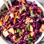 overhead close up of red cabbage salad in white bowl