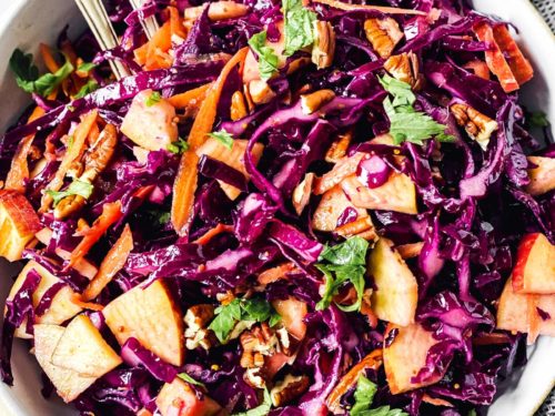 overhead close up of red cabbage salad in white bowl