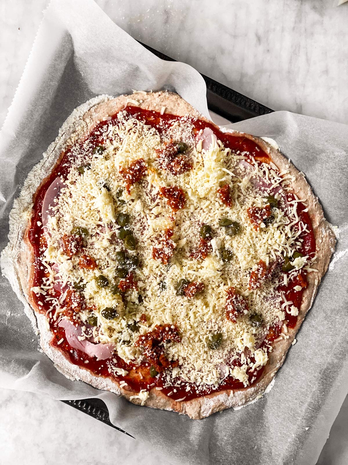 unbaked pizza on whole wheat crust